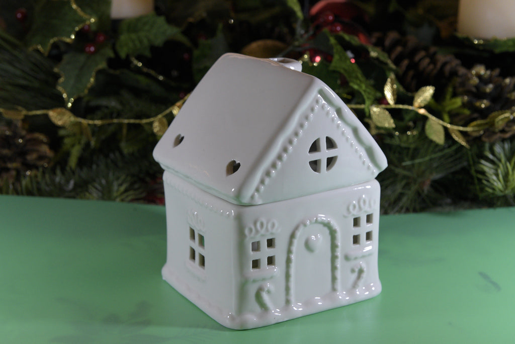 Add a touch of charm to your home with our White Gingerbread House Oil Burner. This beautifully detailed ceramic piece works with both fragrance oils and wax melts, filling your space with delightful scents while adding a whimsical, cottage-inspired accent to your decor.